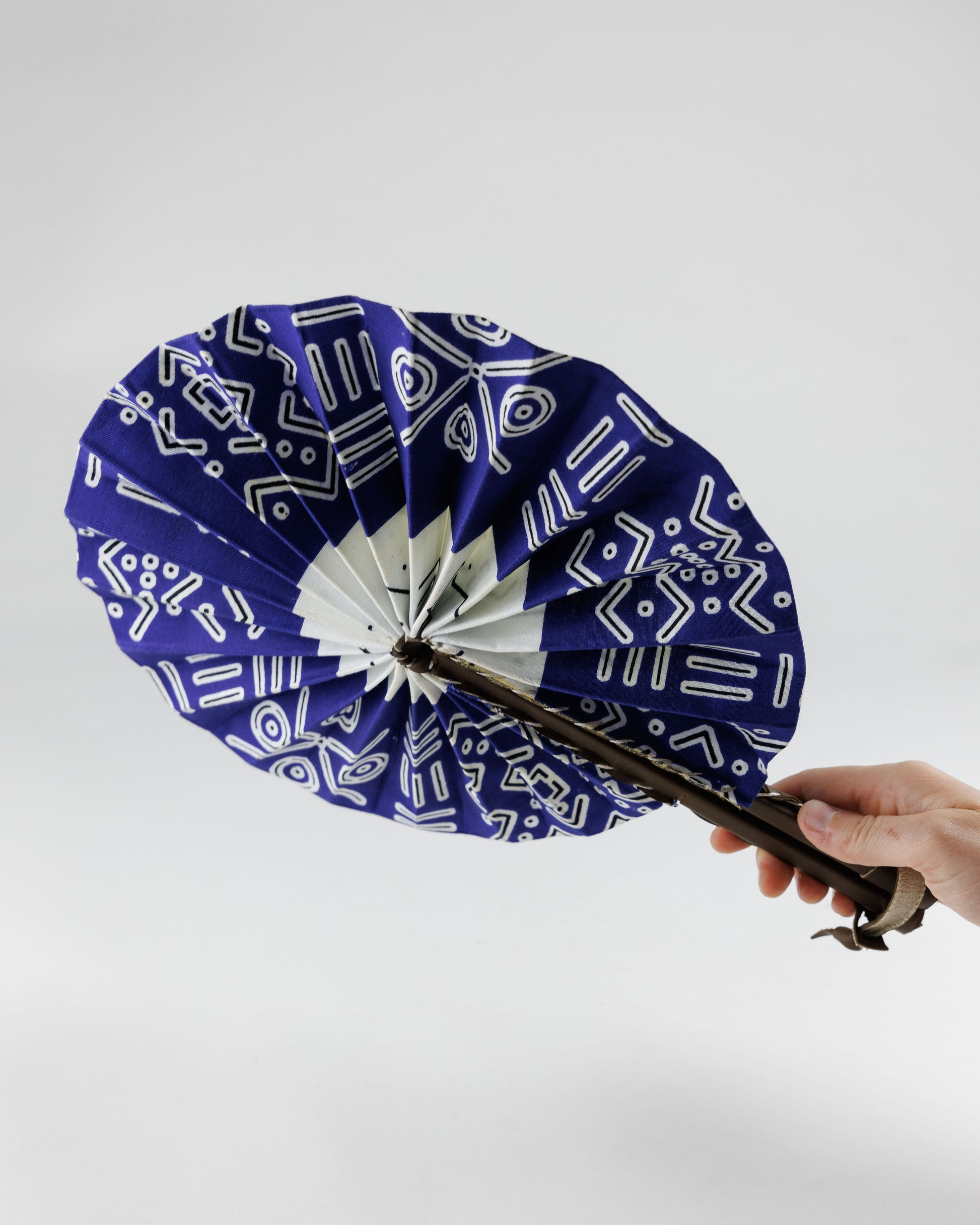 Fan- Collapses for easy storage, made from African wax fabric