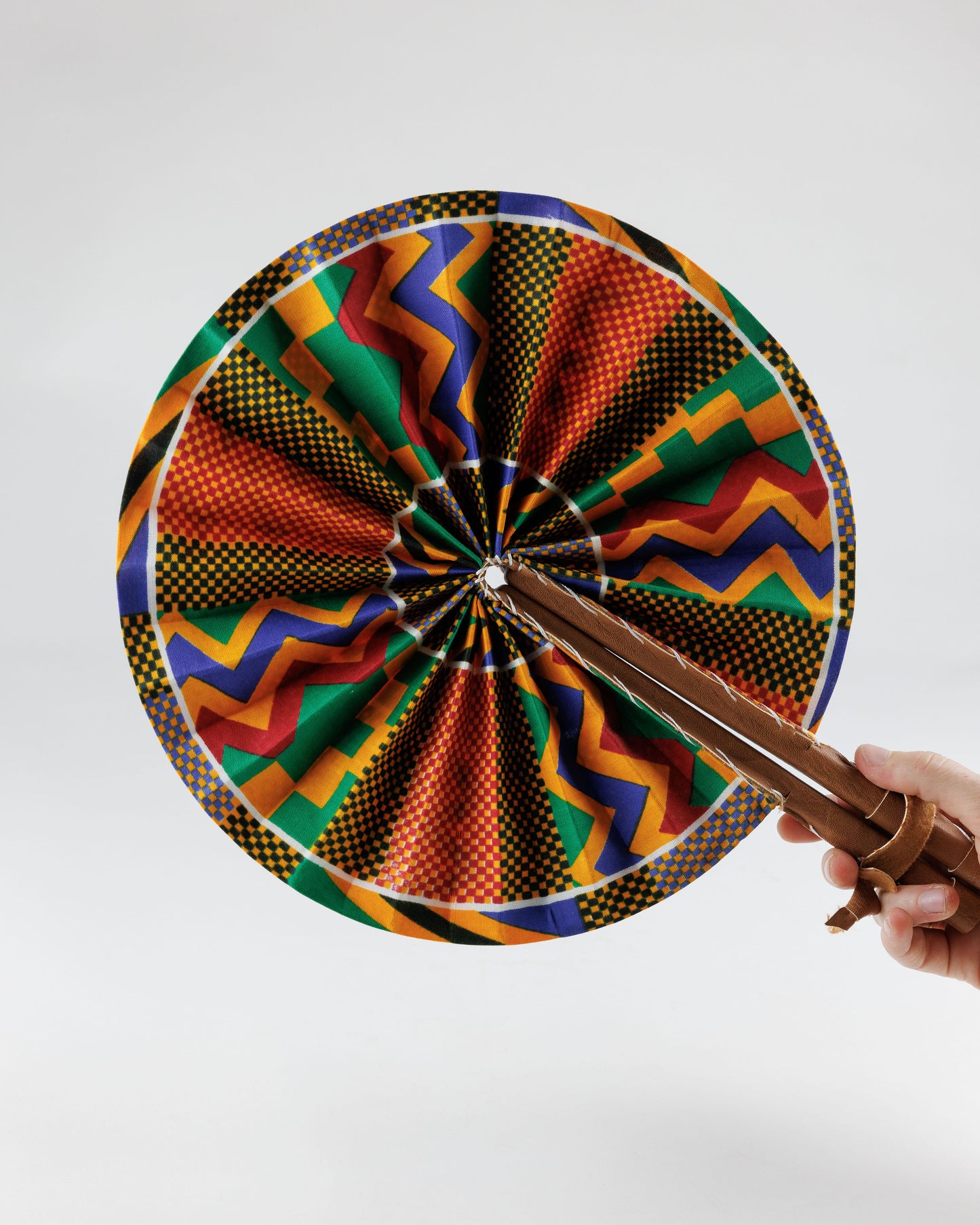 Fan- Collapses for easy storage, made from African wax fabric