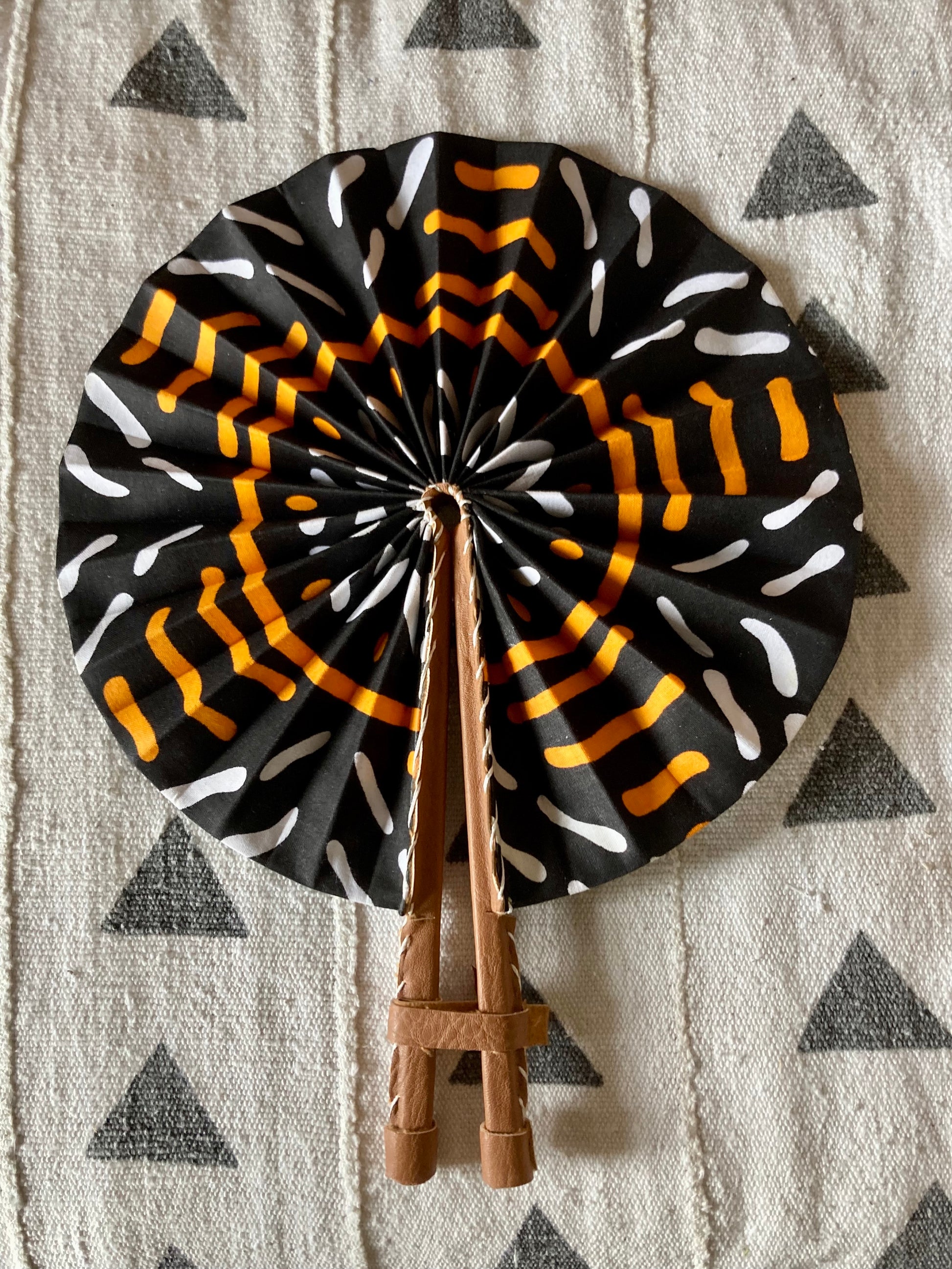 Fan- Collapses for easy storage, made from African wax fabric