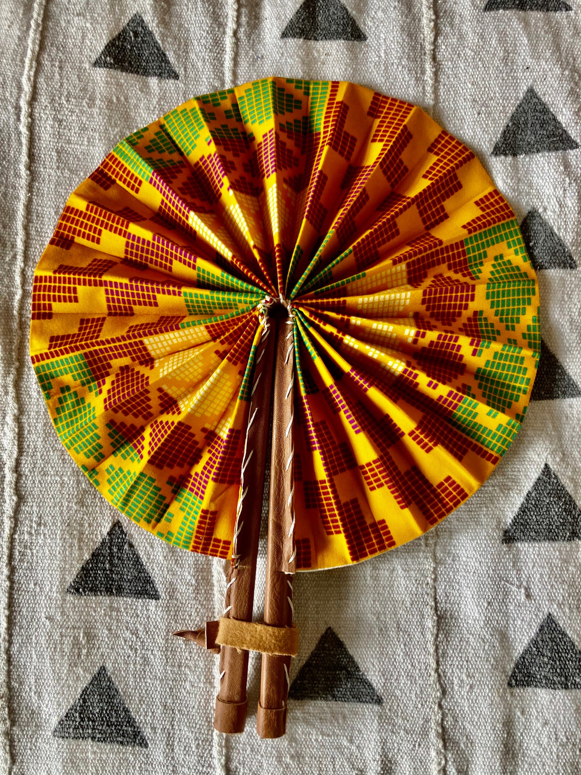 Fan- Collapses for easy storage, made from African wax fabric