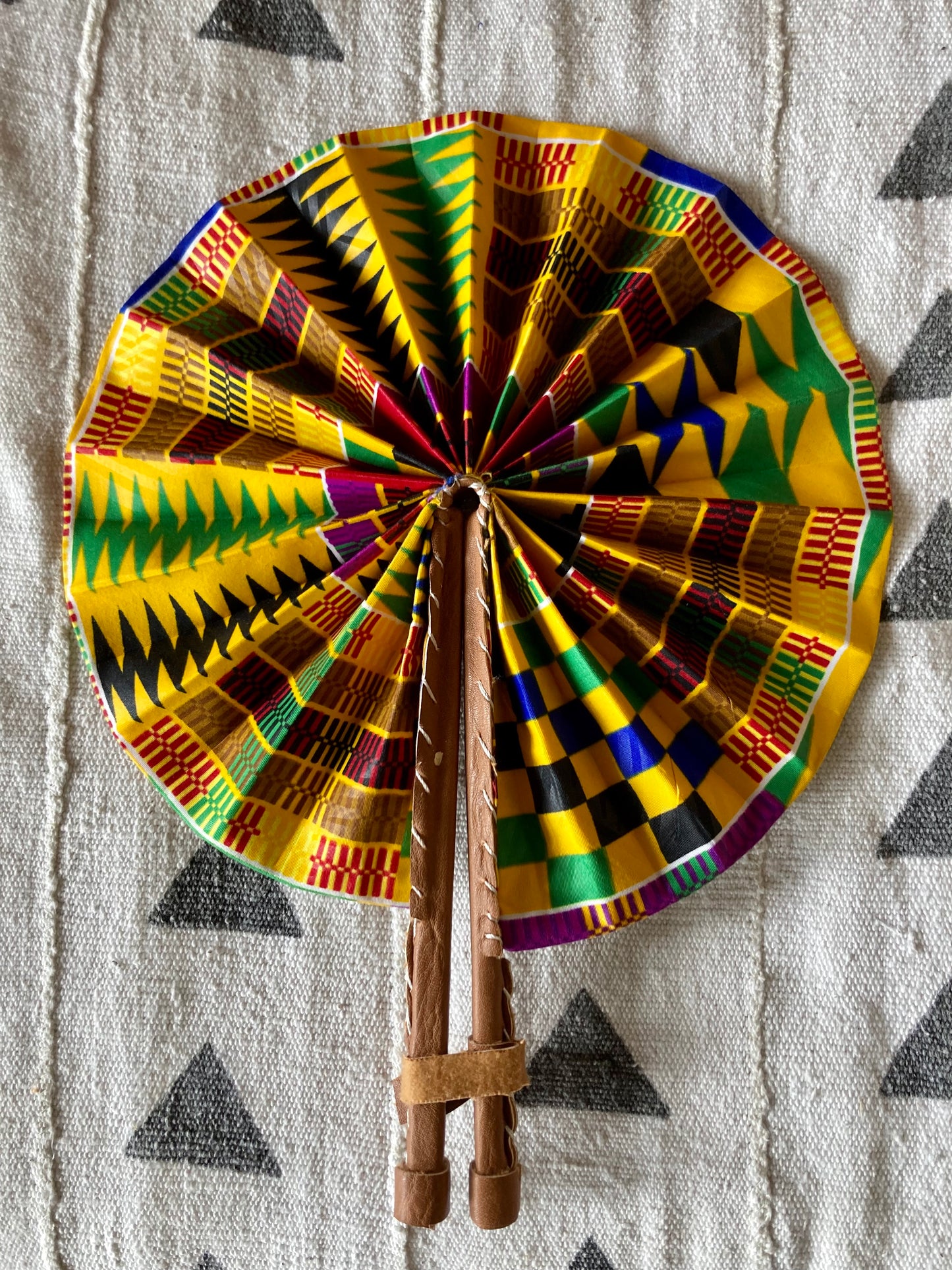 Fan- Collapses for easy storage, made from African wax fabric