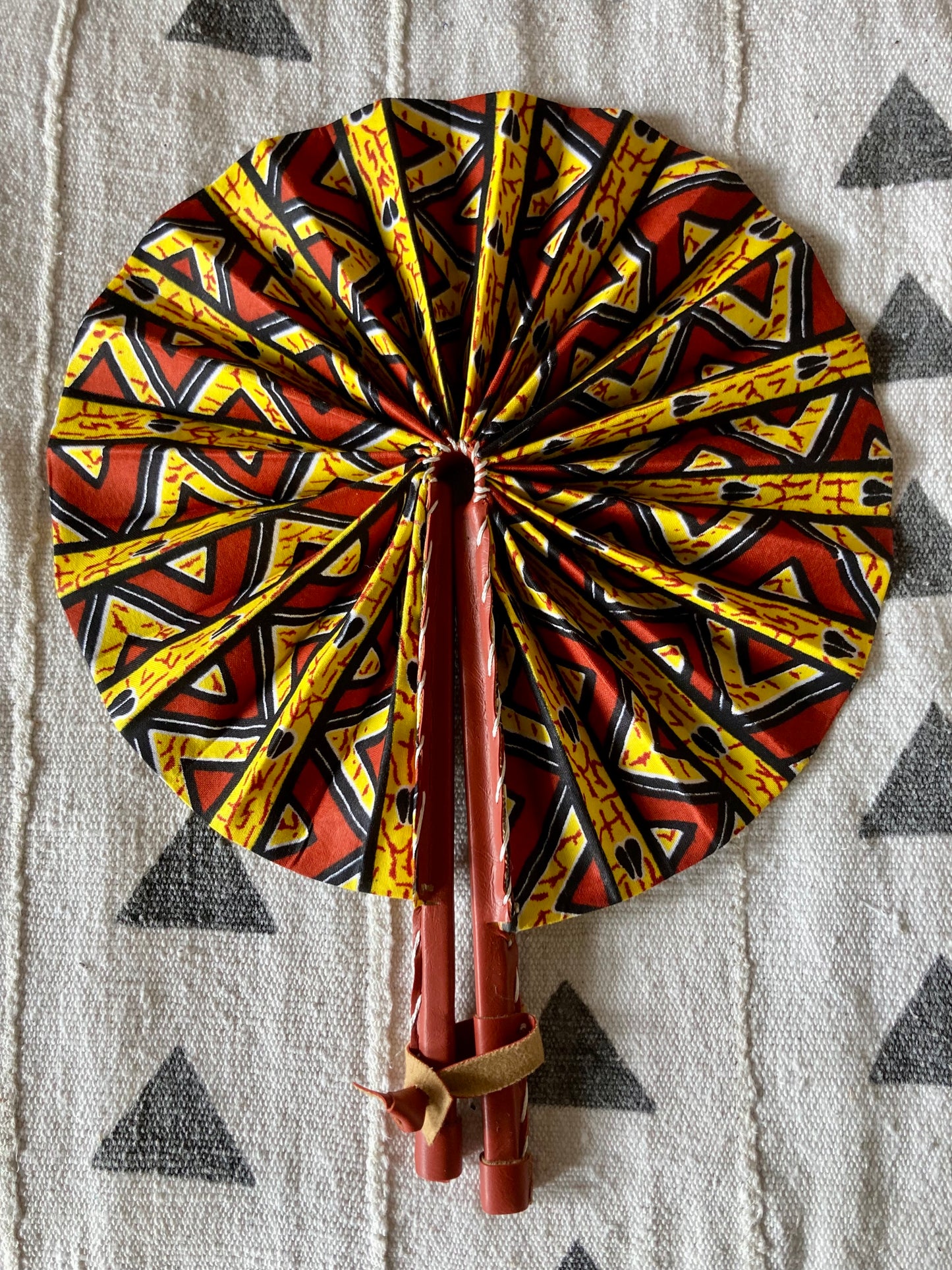 Fan- Collapses for easy storage, made from African wax fabric