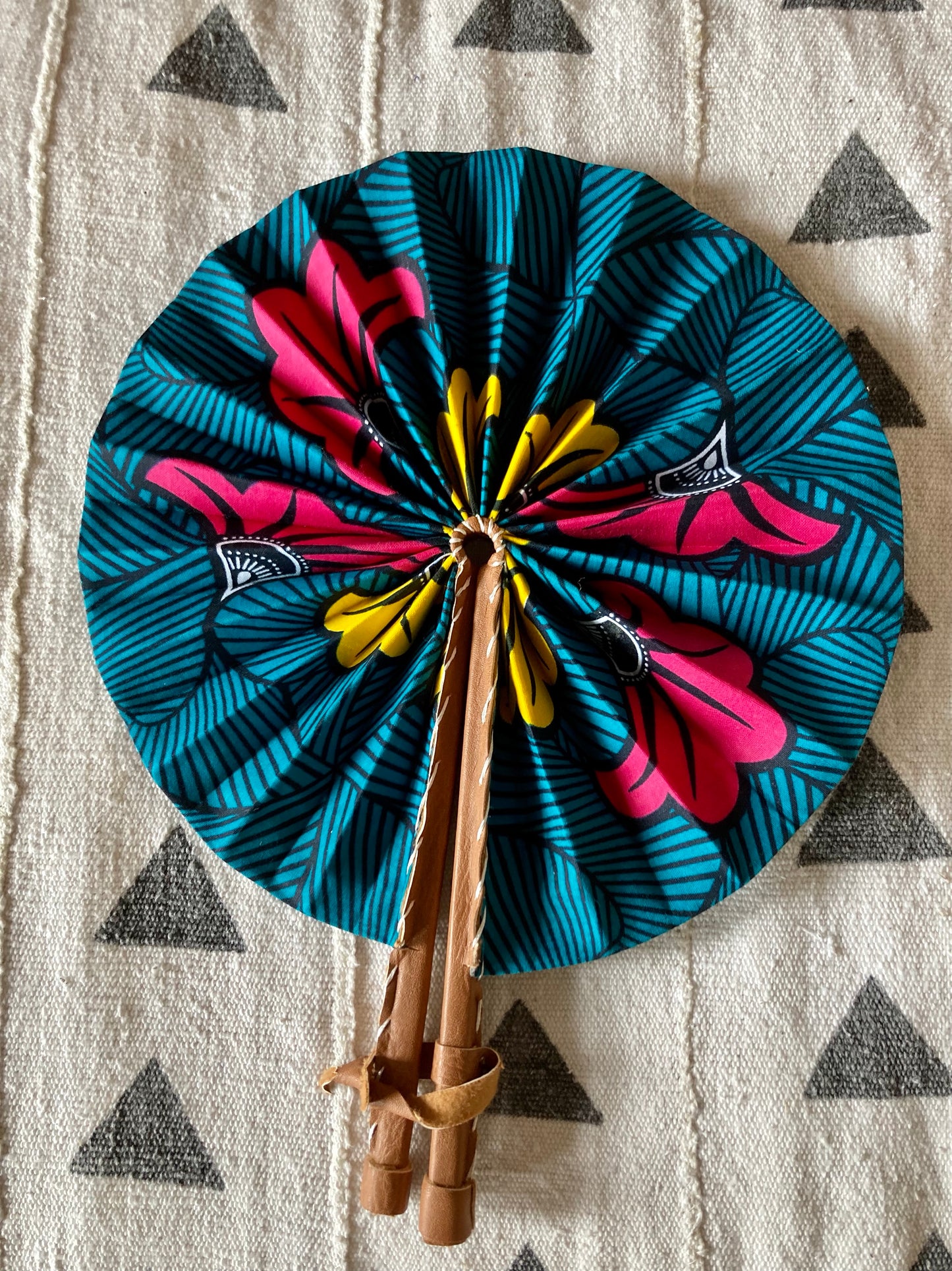 Fan- Collapses for easy storage, made from African wax fabric