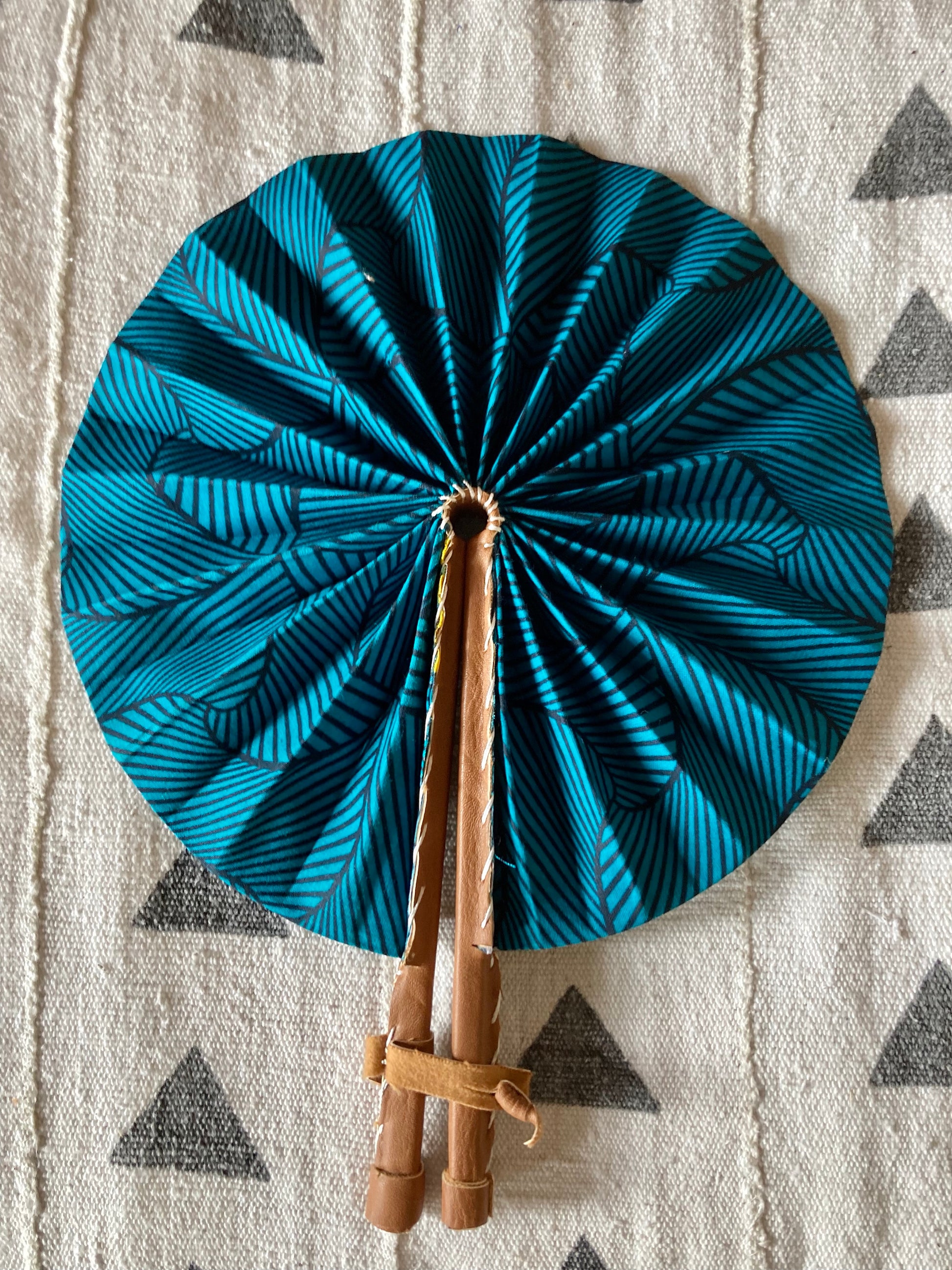 Fan- Collapses for easy storage, made from African wax fabric