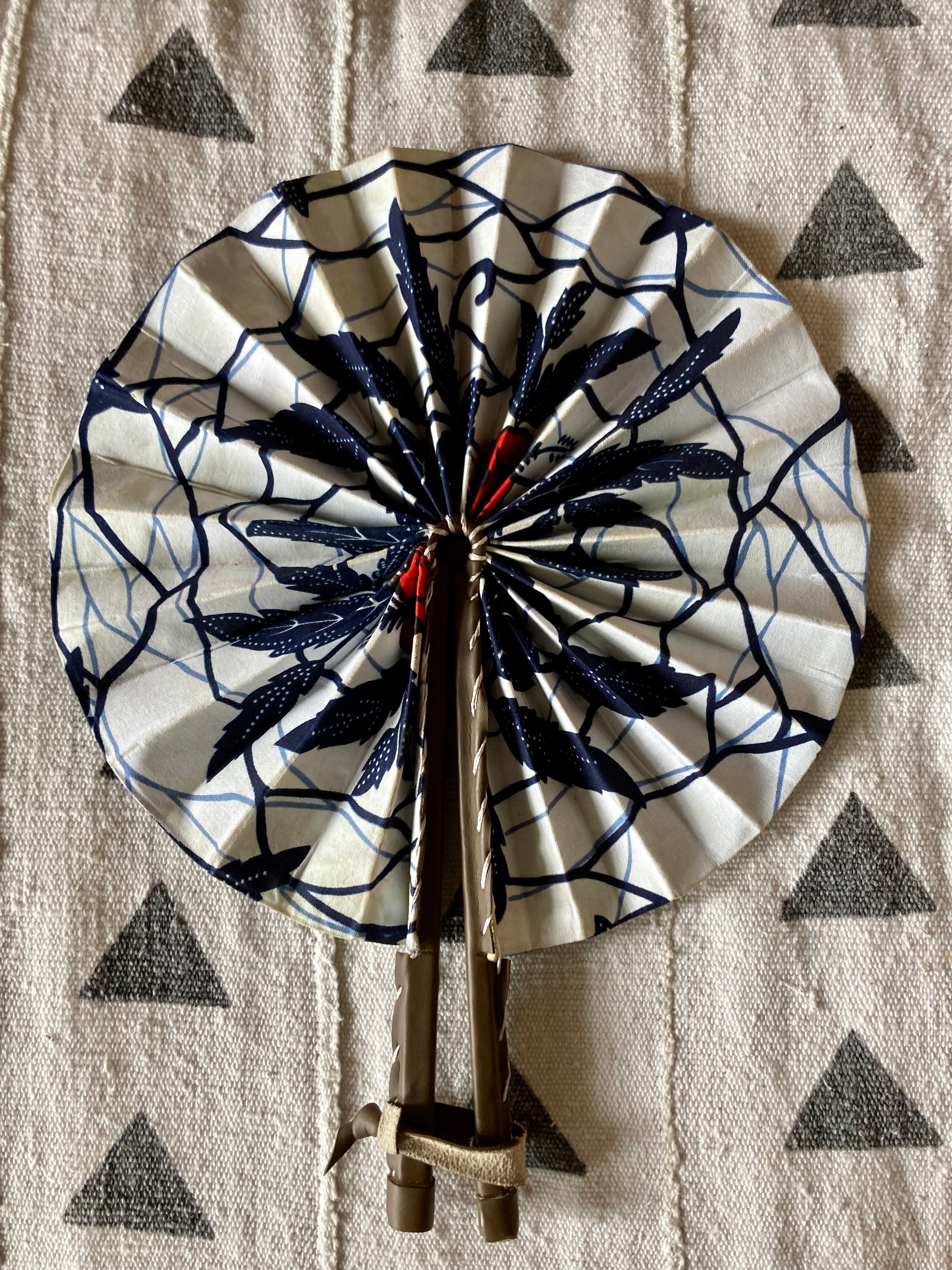 Fan- Collapses for easy storage, made from African wax fabric